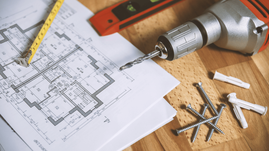 construction tools laying on top of blueprints