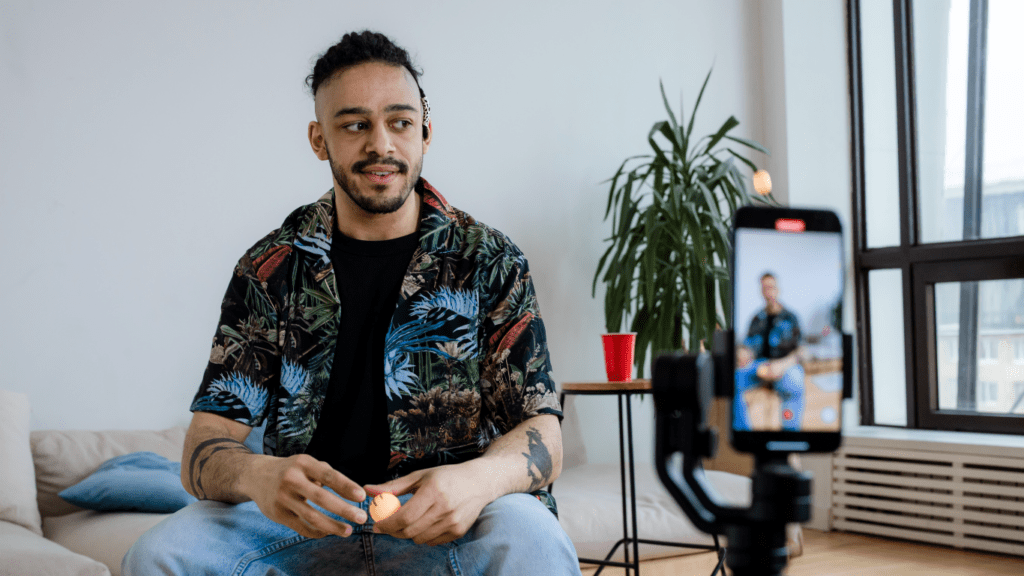 A person sitting on a couch with a camera in front of them