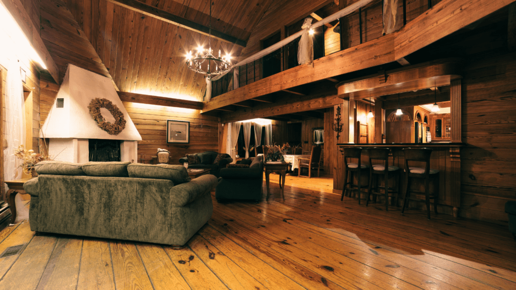 a living room in a log home with wood floors