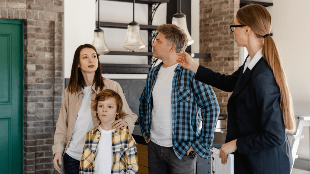 a group of people talking to the real state agent