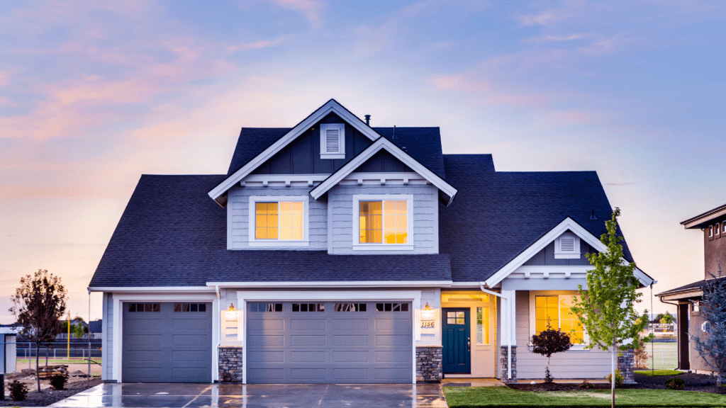 a nice house with a garage at sunset