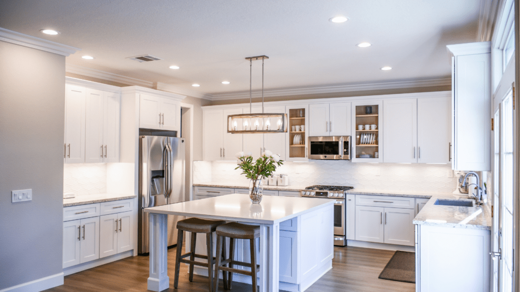 a clean kitchen with white cabinets and hardwood floors