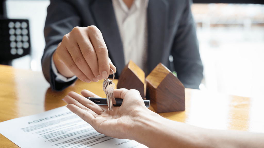 a real state agent holding a model of a house