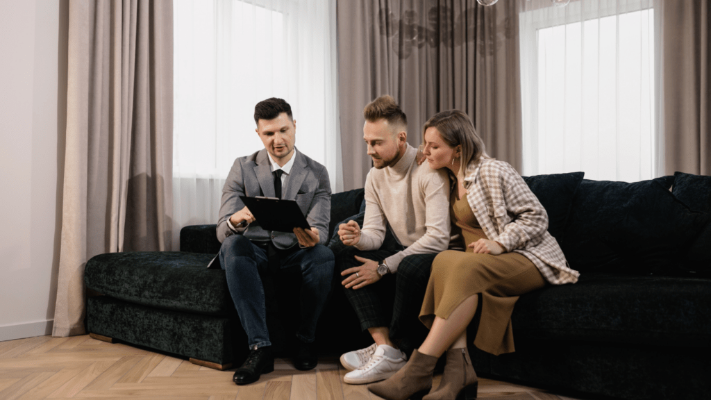 a group of people talking to the real state agent