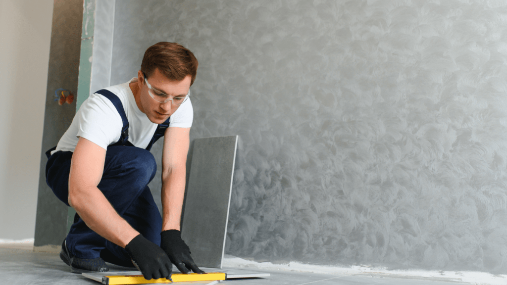 a person is laying tile on the floor