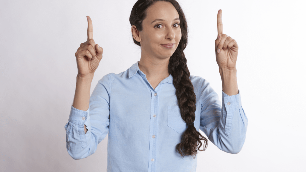 a person is pointing to something with both hands on a blue background