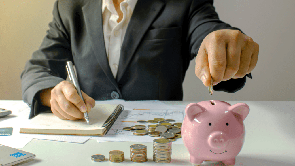 a person putting coins into a piggy bank