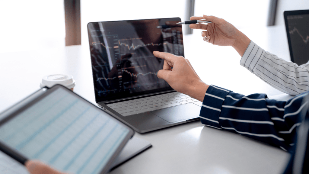 a person sitting at a desk with a laptop on the table