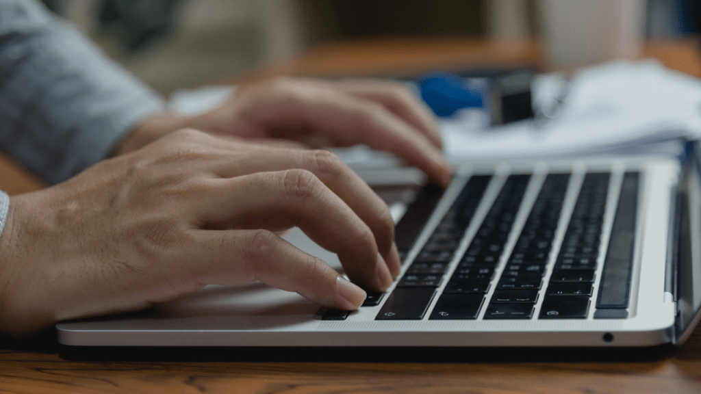 a person typing on a laptop computer