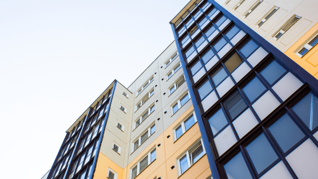 a tall apartment building against a blue sky