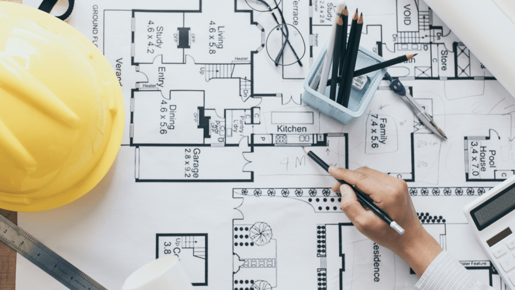 construction tools laying on top of blueprints