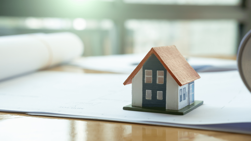 small house models sitting on top of a piece of paper